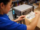 retail-photography-application-back-of-store-zt231-label-applying-500w.webp
